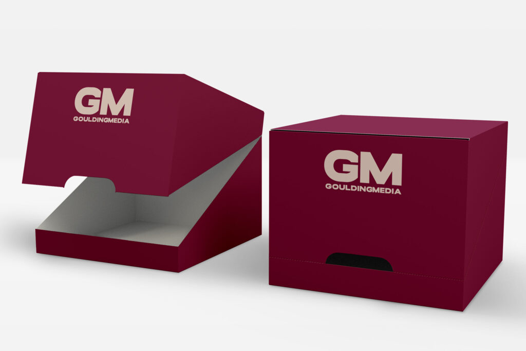 Branded maroon shelf-ready perforated-cases and shipping box with GM Goulding Media logo