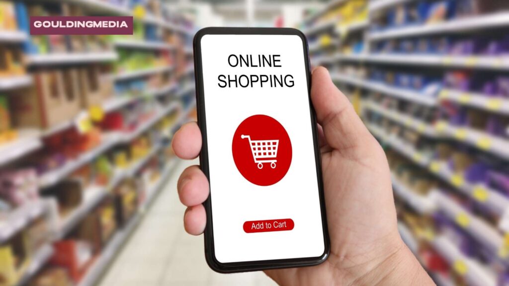 Hand holding a smartphone with an “Online Shopping” app in a supermarket.