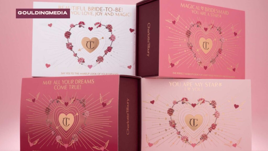 Elegant pink Charlotte Tilbury boxes featuring intricate gold foiling and heart designs, displayed in a stack.