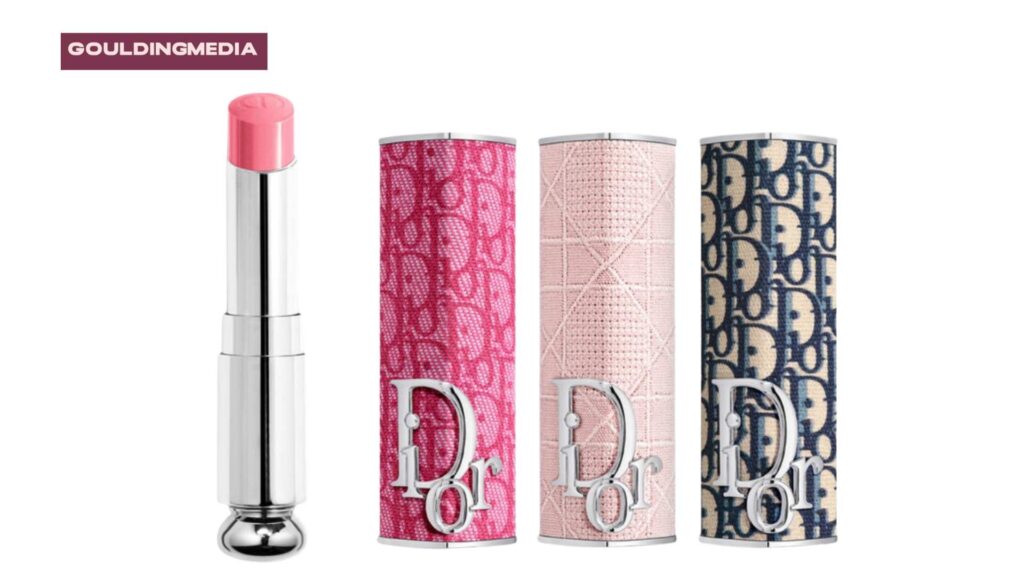 Three Dior lipsticks in designer cases with silver, pink, and denim blue monogrammed patterns.