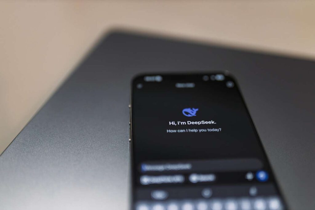 Close-up of a smartphone screen displaying an AI-related interface with blurred background.