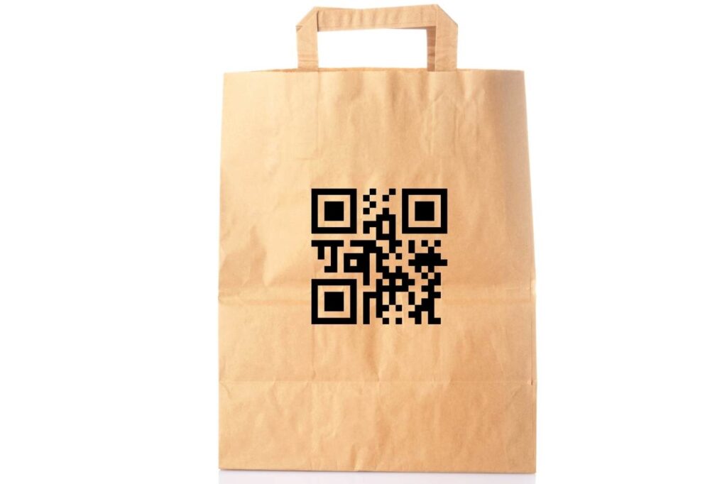 A brown kraft paper shopping bag printed with a large black QR code on the front.