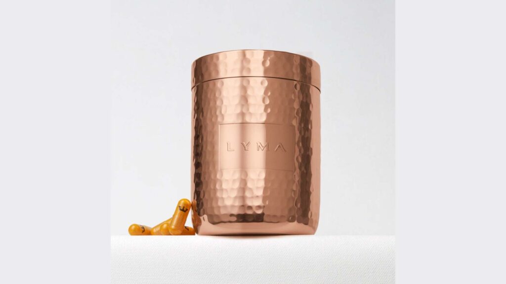 A hammered copper cylindrical canister with a capsule next to it, set against a clean white background.