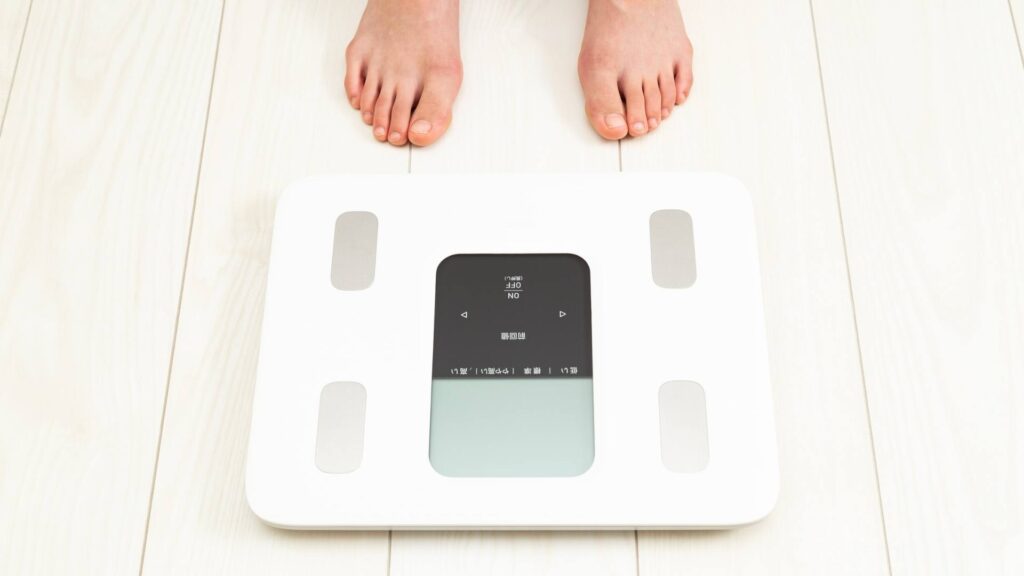 Person standing on a smart body composition scale