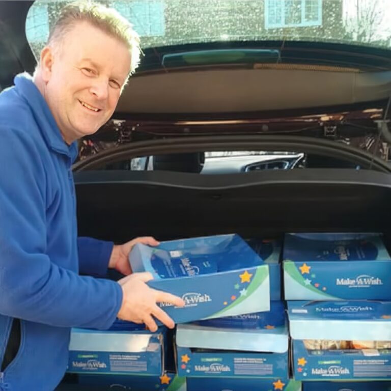 Snack Aid Make a Wish Charity boxes loaded into back of car for delivery