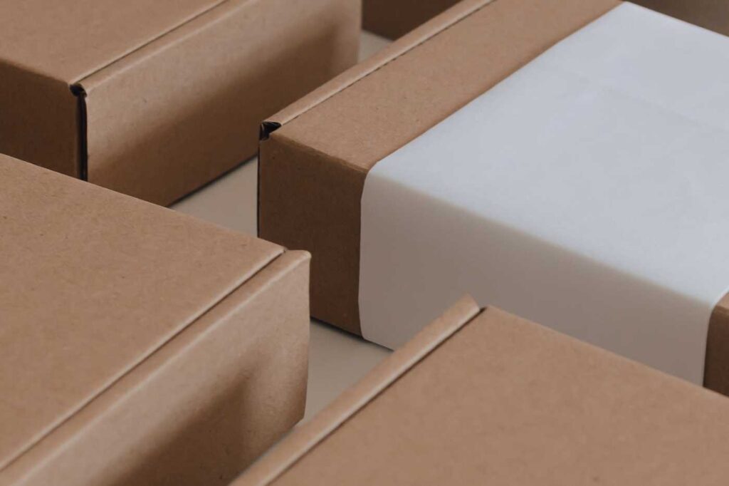 A close-up view of stacked cardboard boxes, some sealed with brown packing tape.